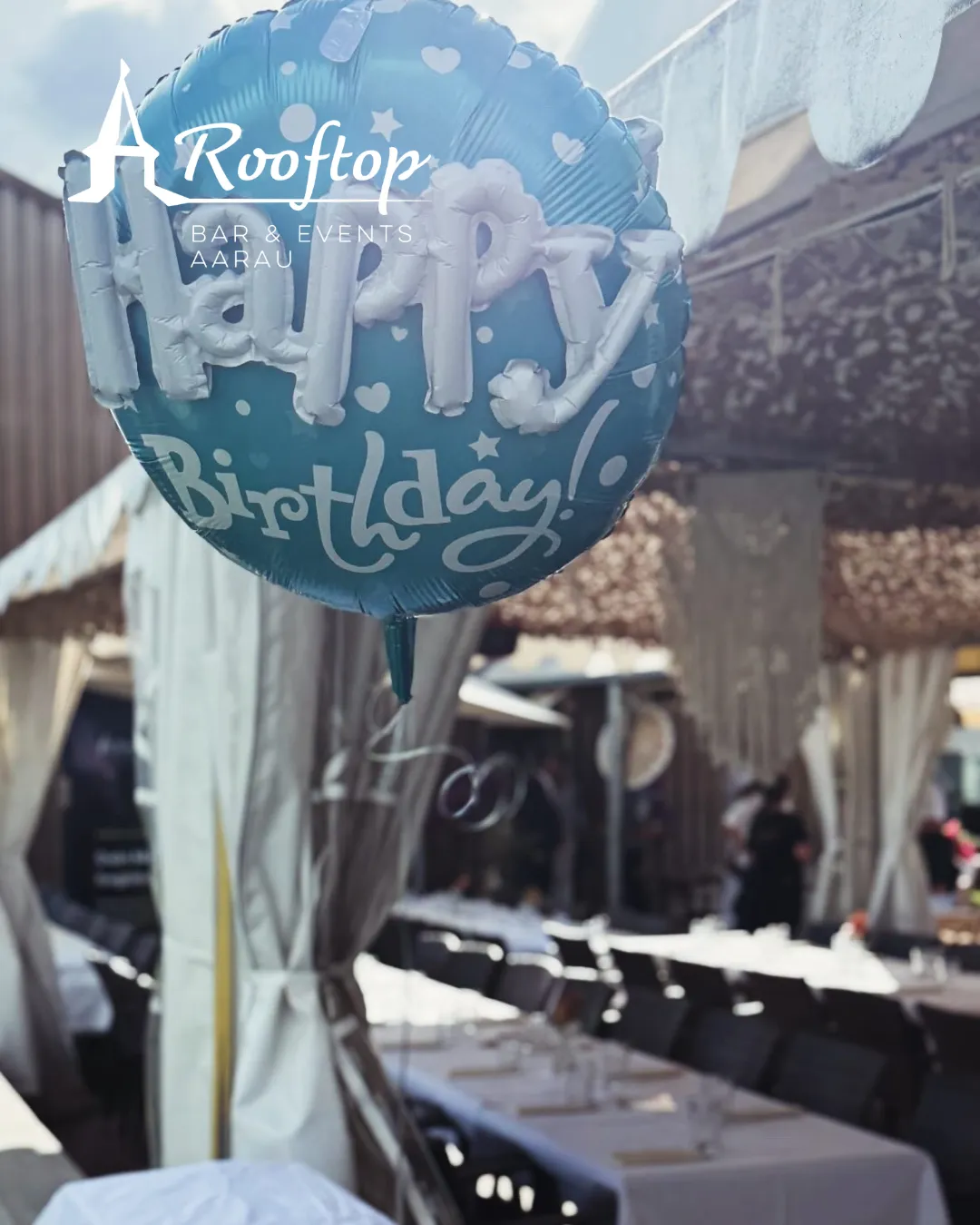 Geburtstagsballon über festlich gedeckten Tischen im Rooftop Aarau